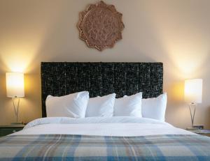 a bedroom with a large white bed with two lamps at Bojangles Guest House in Gretna Green +29 photos