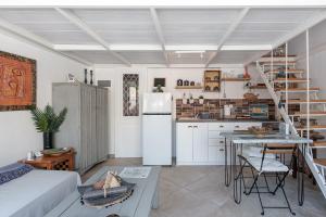 a kitchen with a white refrigerator and a table at La Pausa in Porto Heli