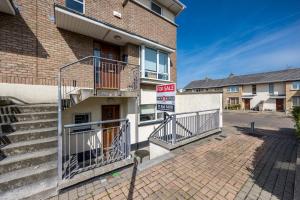 a building with stairs and a sign on it at Cosy 2-Bedroom Apartment near Airport in Dublin +33 photos