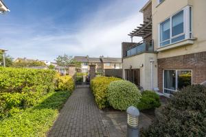 a brick house with a walkway in front of it at Cosy 2-Bedroom Apartment near Airport in Dublin