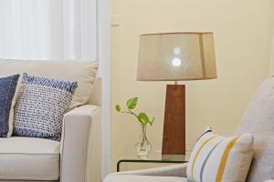 un soggiorno con lampada e divano bianco di Tranquil Retreat in Roseville With Garden Oasis a Sydney