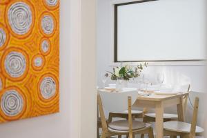 una sala da pranzo con tavolo e un dipinto di Tranquil Retreat in Roseville With Garden Oasis a Sydney Altre 19 foto