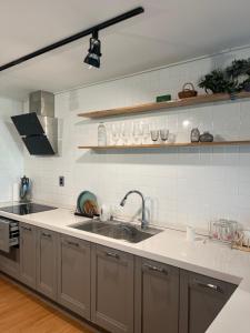 a kitchen with a sink and a counter top at Sogobe Jeju House in Jeju