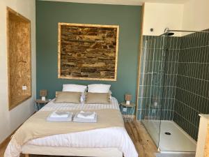 a bedroom with a large bed and a shower at Duplex Centre Ville Lannion in Lannion