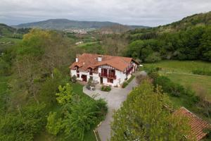 an aerial view of a house in the hills at Apartamentos rurales AGIÑAGA in Irún