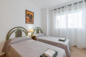 a room with two beds and a window at Isabela in Calpe