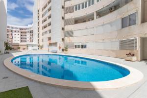 a swimming pool in front of a building at Isabela in Calpe