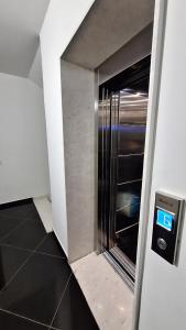 a elevator in a room with a walk in closet at White Palace in Vlorë