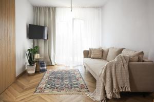 a living room with a couch and a rug at MEC-2 Apartment Mechelinki in Mechelinki