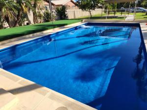 a large swimming pool with blue water at Sun River Resort in Mildura
