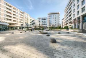 a large plaza in a city with tall buildings at Plac Unii by NorthSide Apartments in Gdynia