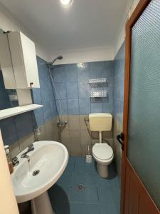 a small bathroom with a sink and a toilet at Mesaiz 2 in Vlorë