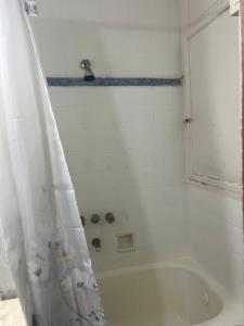 a bathroom with a shower with a white tub at Corazón obelisco 4 in Buenos Aires +13 photos