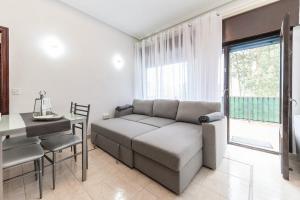a living room with a couch and a table at Luxury Coastal Apartment with Stunning Sea Views in Liñero +25 photos