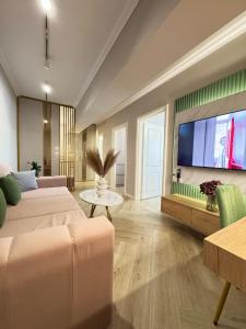 a living room with a couch and a flat screen tv at Modern & Glam Apartments Evergreen Towers Underground Parking in Iaşi
