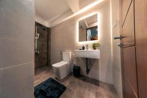 a bathroom with a white toilet and a sink at The Blackberry Retreat Kandy in Kandy