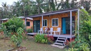 a small house with white chairs and a porch at AiOonHomestay Twins Room in Ban Bang Bao