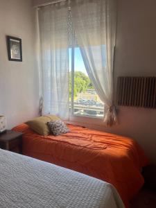 a bedroom with two beds and a window at Corazón obelisco 4 in Buenos Aires