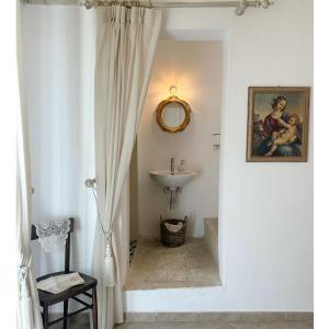 a bathroom with a sink and a mirror at Dimora Santa Domenica in Scorrano
