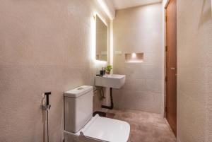 a bathroom with a white toilet and a sink at The Blackberry Retreat Kandy in Kandy +63 photos
