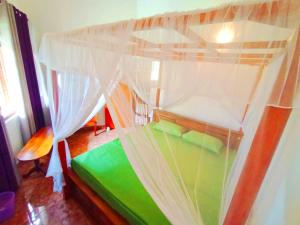 a bed with a canopy in a room at Bluebell Villa Mirissa in Kamburugamuwa