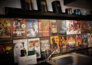 a bunch of movie posters on a wall above a sink at Le cinoche in Woustviller +12 photos