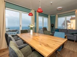 a dining room with a wooden table and chairs at Haus Waterkant - traumhafter Meerblick und Garten in Sassnitz