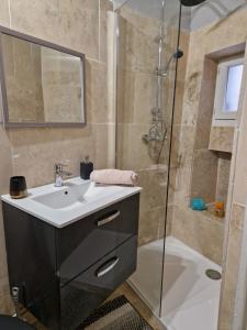 a bathroom with a sink and a shower at Spacious village house completely renovated in Pennautier