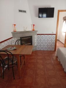 a living room with a table and a fireplace at Tío Abraham in El Raso +15 photos
