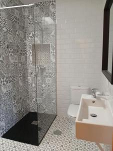 a bathroom with a shower and a toilet and a sink at Tío Abraham in El Raso