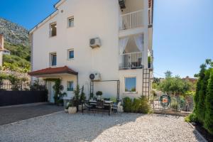 a white building with a table in front of it at Apartment GL in Stanići +39 photos