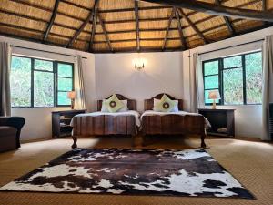 a bedroom with two beds and two windows at Mabuda Guest Farm in Stegi +47 photos