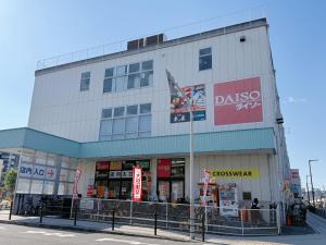 a building with a store on the corner of a street at NewDayHouse日式洋房独栋最多住10人 新今宫站近温泉通天阁天王寺 机场直达 半小时到世博会 in Osaka