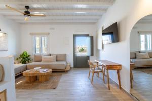 a living room with a couch and a table at SilvAir by Silvernoses, Mykonos in Dexamenes