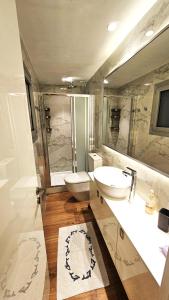 a bathroom with two sinks and a large mirror at The Suave - Limassol City Centre Luxury in Limassol +11 photos