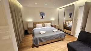 a bedroom with a bed with two towels on it at The Suave - Limassol City Centre Luxury in Limassol