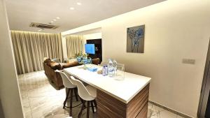 a living room with a table and some chairs at The Suave - Limassol City Centre Luxury in Limassol