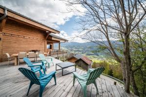 a deck with chairs and a table on a house at Chalet Célestine 7ch - '4 sdb' in Verchaix