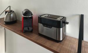 a toaster on a wooden shelf in a kitchen at La Rêverie in Rezé