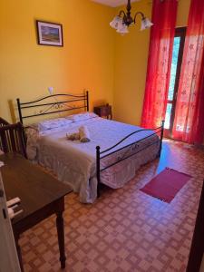 a bedroom with a bed with a stuffed animal on it at Casa Franceschini in Poggio Mirteto