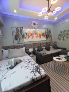 a bedroom with a bed and a couch at Cebu Stay Rental - Sunvida Tower Residences in Sampong