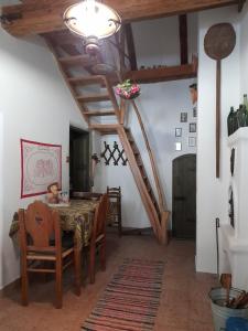 a dining room with a table and wooden ceilings at Kemencés Vendégház in Kővágószőlős +32 photos