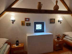 a living room with a tv on top of a table at Kemencés Vendégház in Kővágószőlős