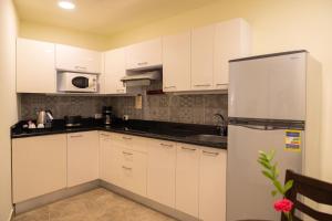 A kitchen or kitchenette at Swiss Inn Plaza Hotel