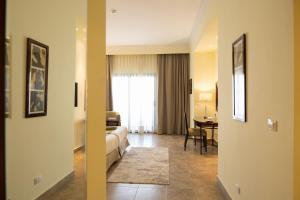 A bed or beds in a room at Swiss Inn Plaza Hotel