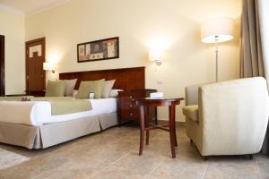 A bed or beds in a room at Swiss Inn Plaza Hotel