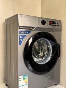 a washing machine with a washer in a room at Marvin Suites in Al Wajh