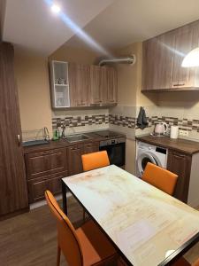a kitchen with a table and chairs and a table and a kitchen with a stove at Danube View 2 in Vidin