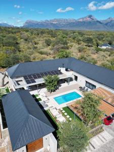 an aerial view of a house with solar panels on the roof at blydebushvilla in Hoedspruit