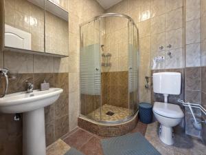 a bathroom with a shower and a toilet and a sink at VILA TARA in Sutomore +137 photos